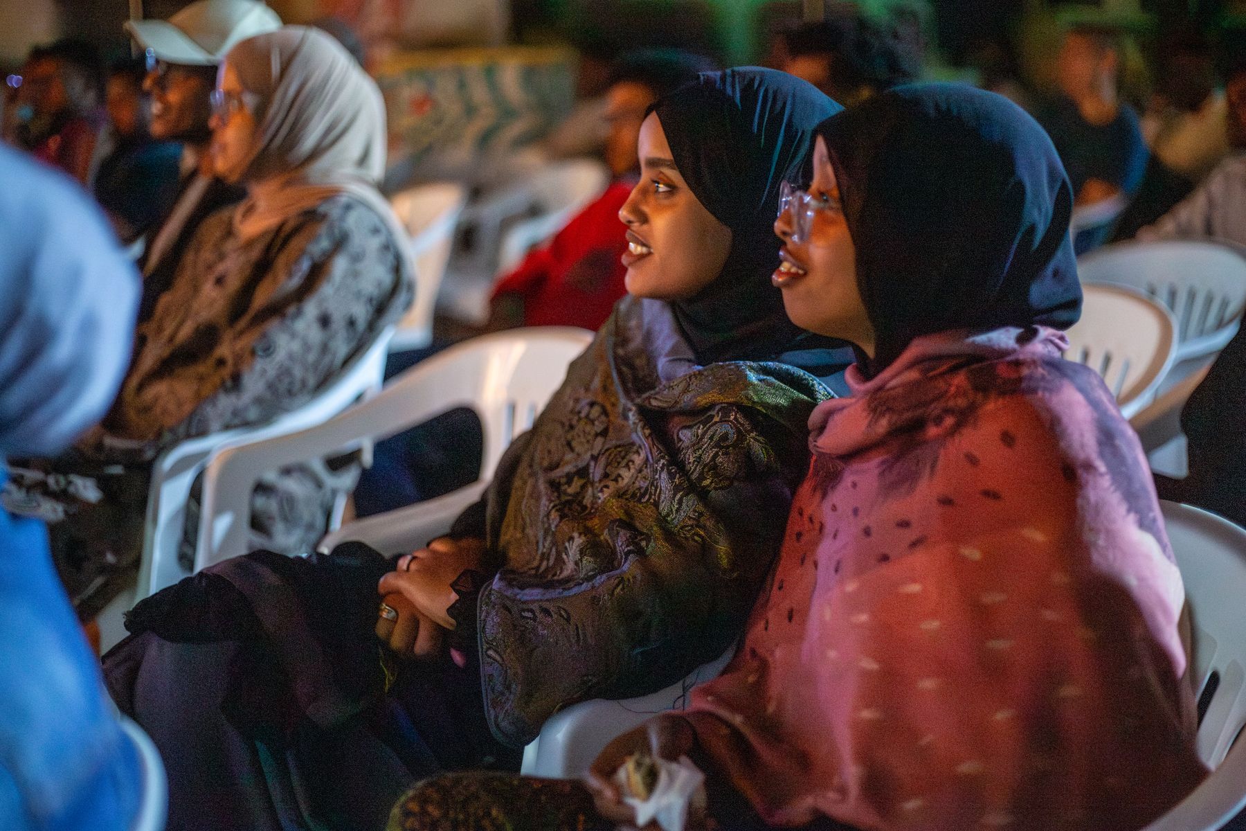 Women in the audience watch a film at the first edition