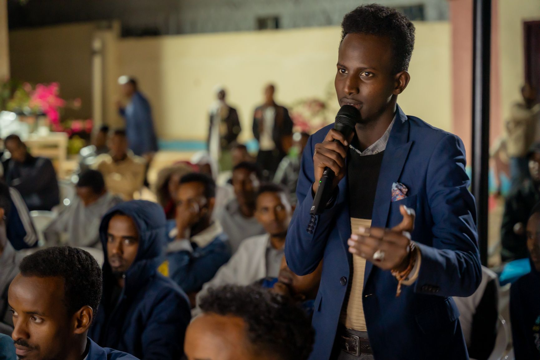 A man in the audience stands to speak during the talk